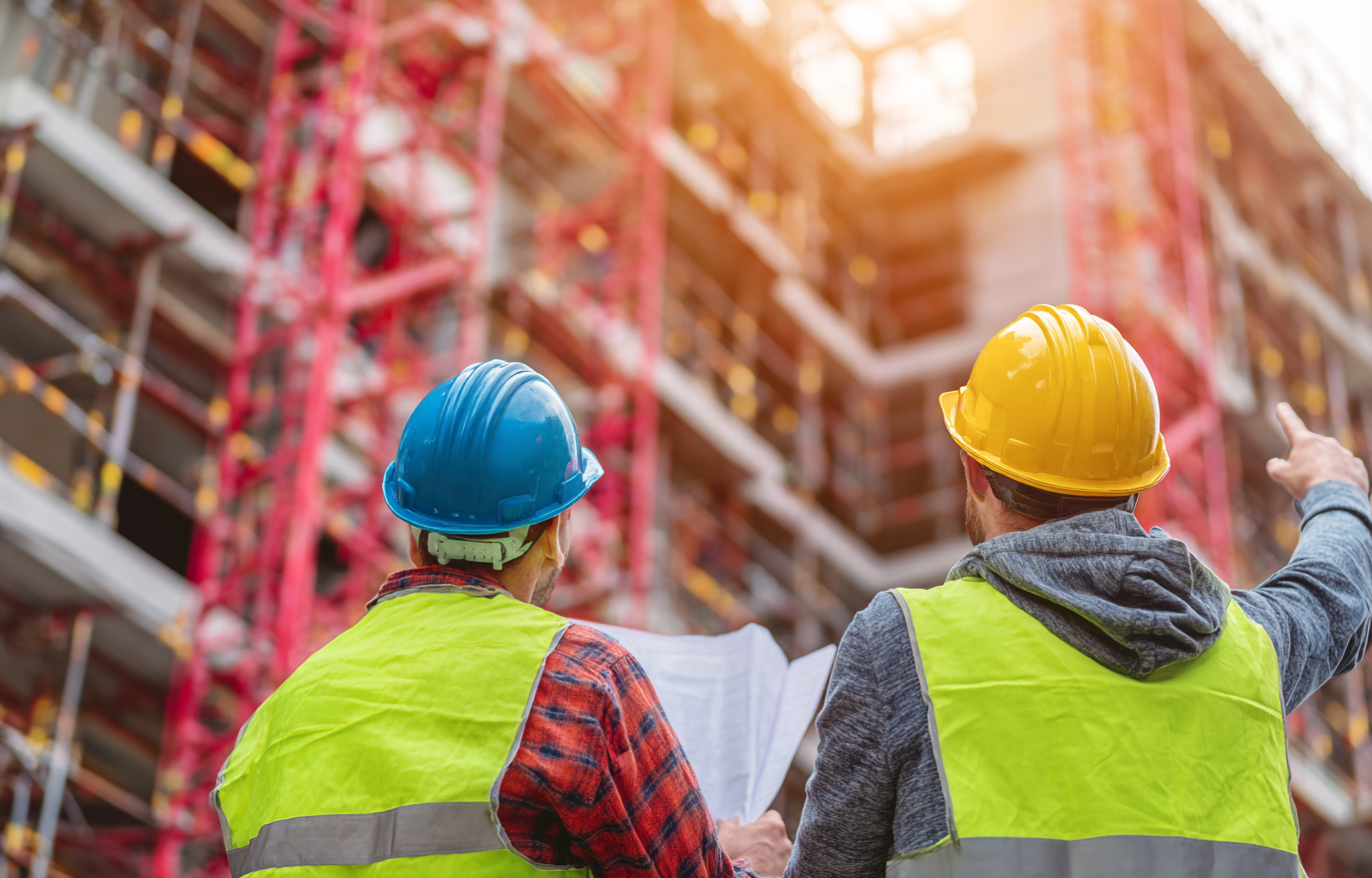 jay081480_77365_two_male_construction_workers_in_giallo_and_gre_46780385-0f0c-4bcc-9fb4-2f54dcf47abb